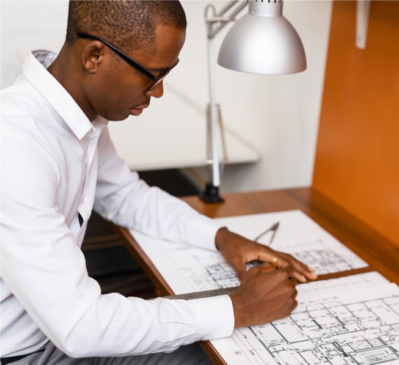 Acumen engineer reviewing project blueprints