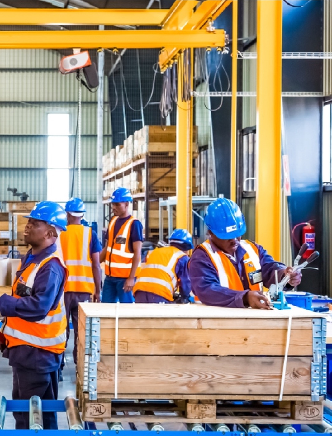 Workers handling equipment in an industrial facility