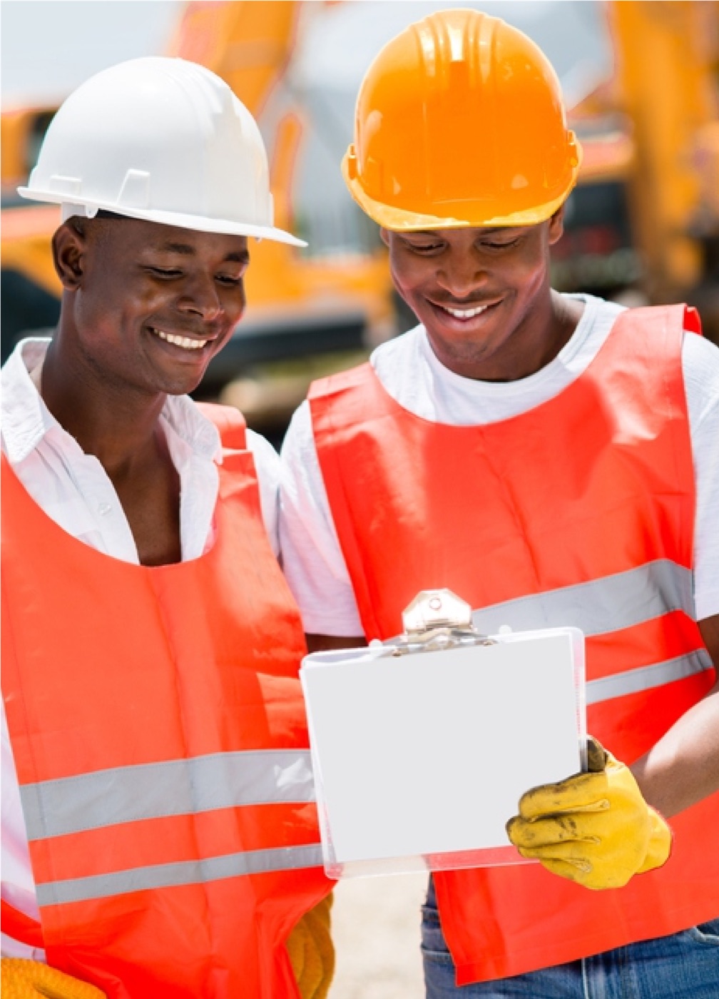 Two Acumen field professionals in safety gear reviewing work